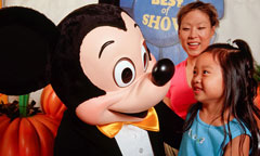 Mickey Mouse greets a guest at the Judge’s Tent inside the Magic Kingdom.